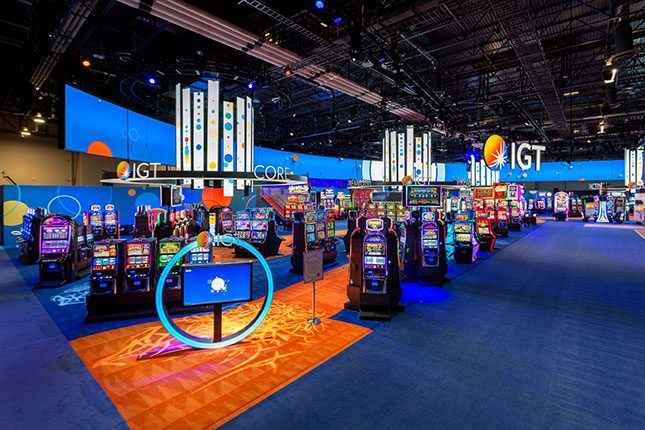 An elevated perspective of slot machines and video chandeliers at the IGT booth at G2E 2016.