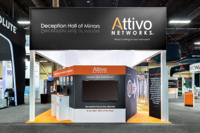 Attivo exhibit with a black second story banner, a large video screen on the first level, kiosks with video screens on the left, and angled walls leading to a hall of mirrors.