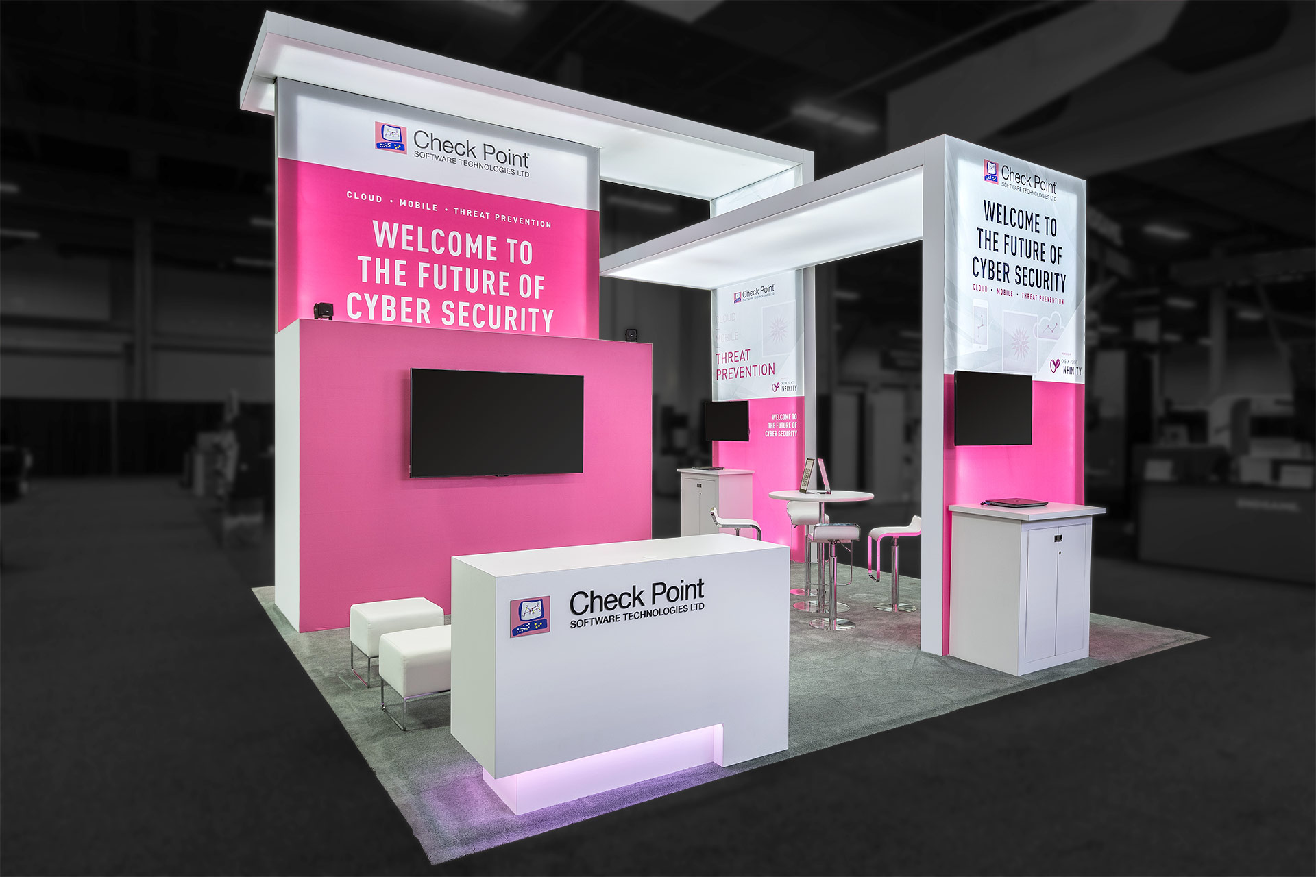 A white-and-pink rear-illuminated trade show exhibit with angled wall-and-ceiling panels.
