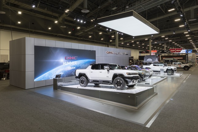 Four electric vehicles at the 2021 SEMA Hummer EV Exhibit at West Hall in Las Vegas Convention Center.