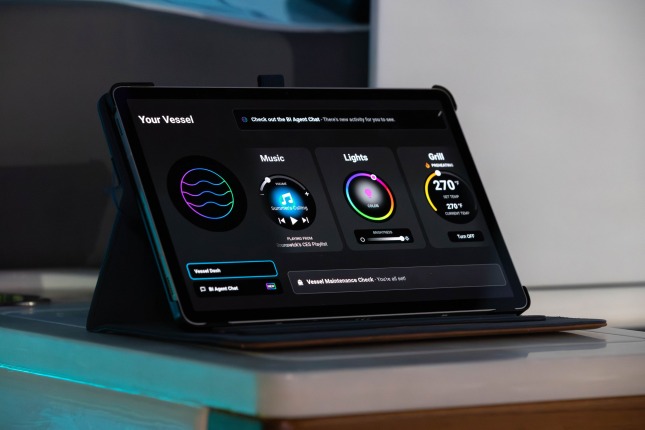A closeup of the Brunswick BI Agent console on a tablet at the Brunswick exhibit at CES 2026. The console is mostly black with controls for Music, Lights, and Grill visible.